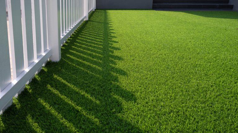 green,artificial,turf,and,white,wooden,picket,in,front,yard